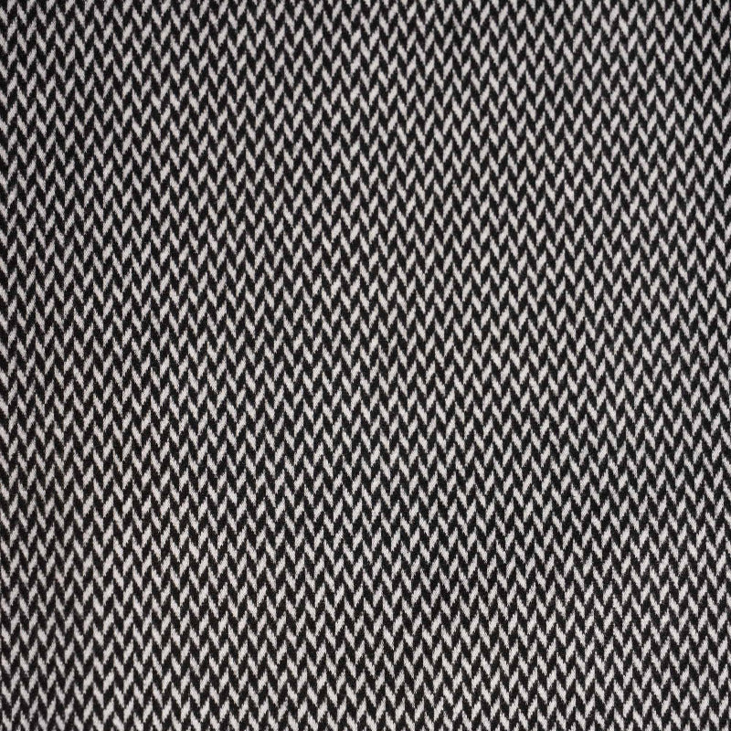 Close-up of the black and white herringbone fabric pattern on the Vassalli Knit Jacket - Xander, highlighting its repeating zigzag design.