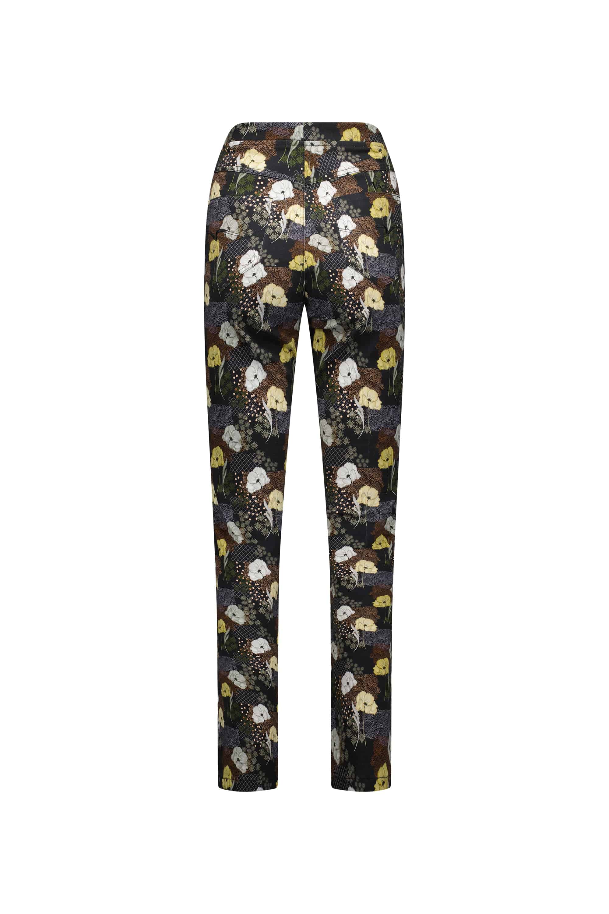 Back view of Vassalli’s Bay Pull On - Karma slim leg pants, showcasing stretch fabric and an abstract floral and polka dot pattern in yellow, white, and brown on a dark background.