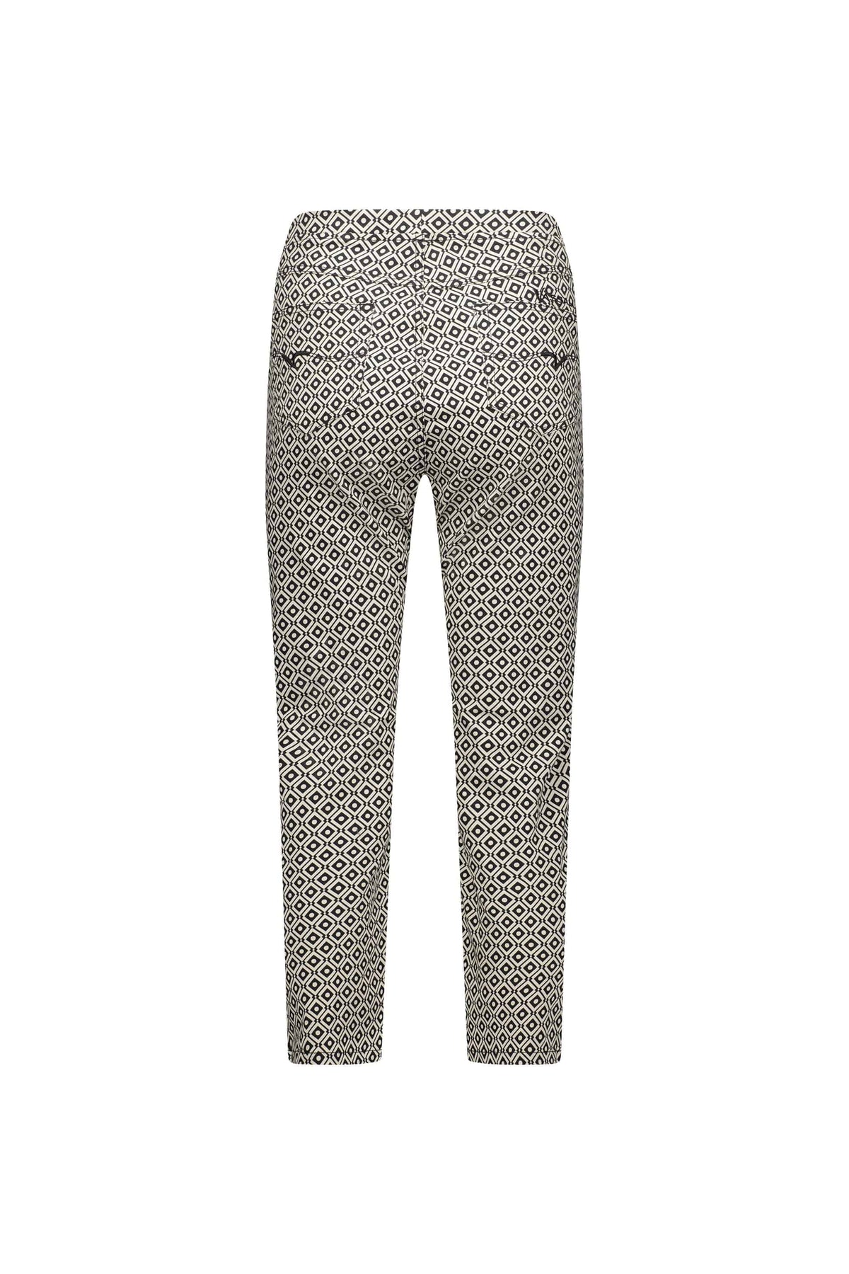 Back view of Vassalli Sierra 7/8 Pant - Sahara, ankle-length pants in a slim pull-on style, showcasing a black and white geometric diamond print on a light background, displayed against a plain white backdrop.