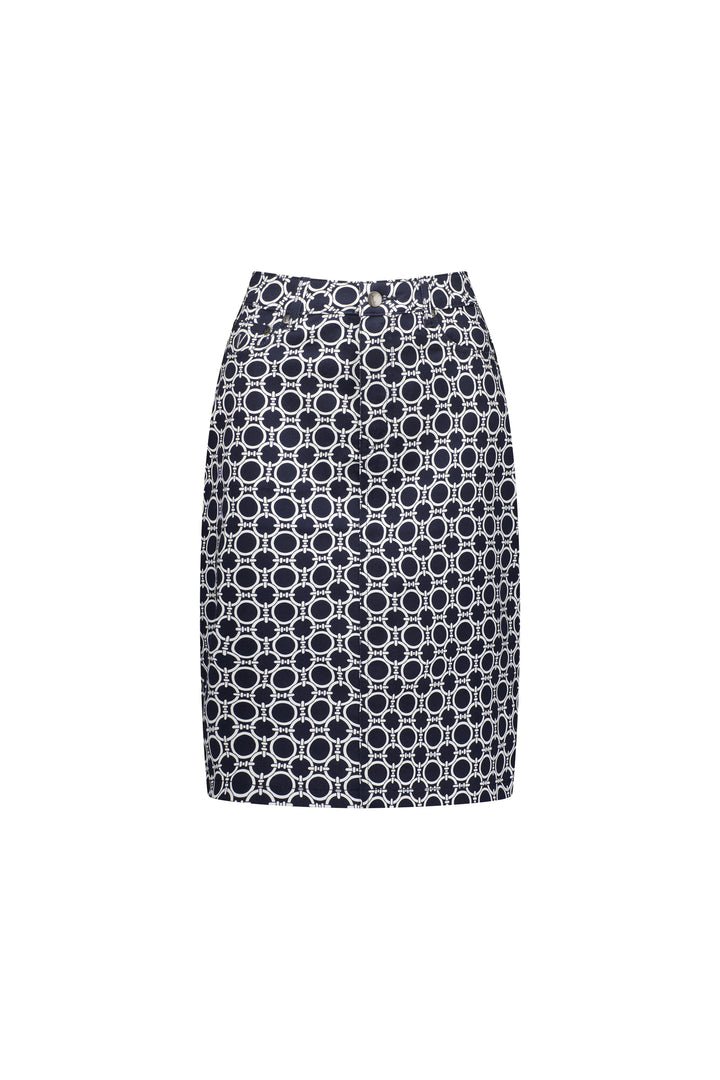 The Vassalli Poppy Skirt - Arlo is a knee-length, high-waisted skirt featuring a navy base with a white geometric circular pattern, crafted from stretch fabric and shown against a plain white background.