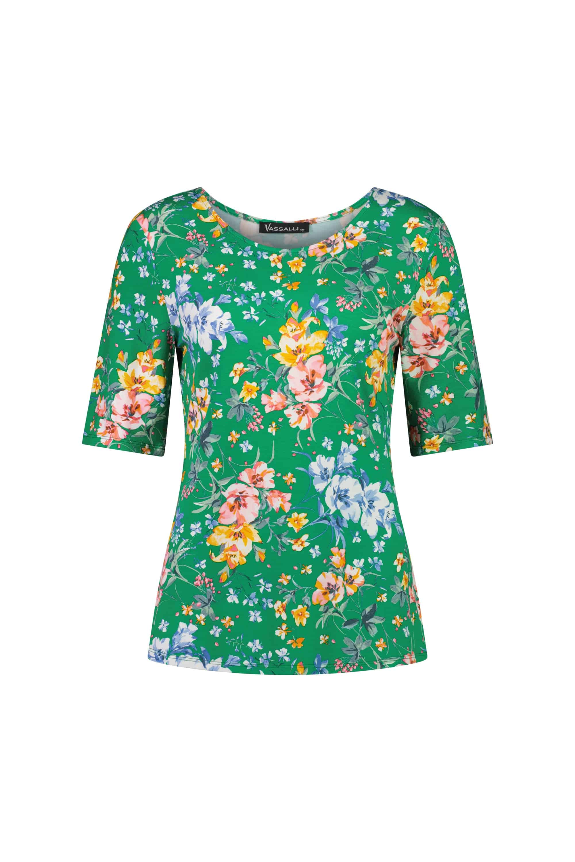 The Vassalli Carmen Top - Lush is a green relaxed fit women's rayon jersey top with a colorful floral pattern in pink, orange, yellow, and blue on a white background.
