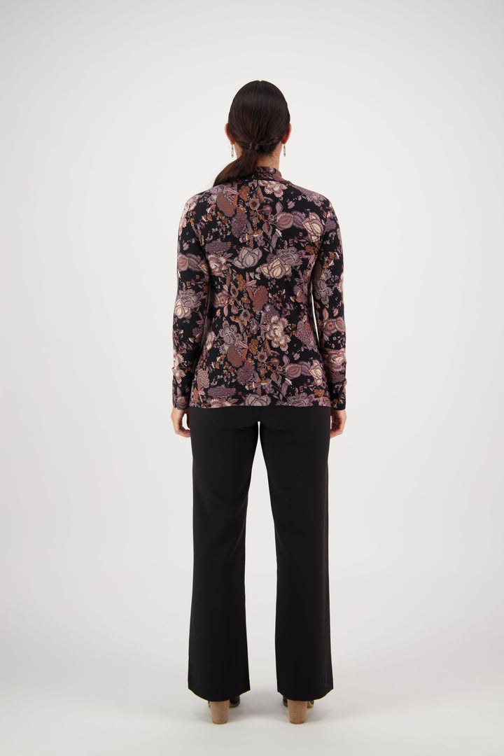 A person with long dark hair, seen from behind, wears the Vassalli Foundation Top - Vintage with black pants, standing against a plain white background.