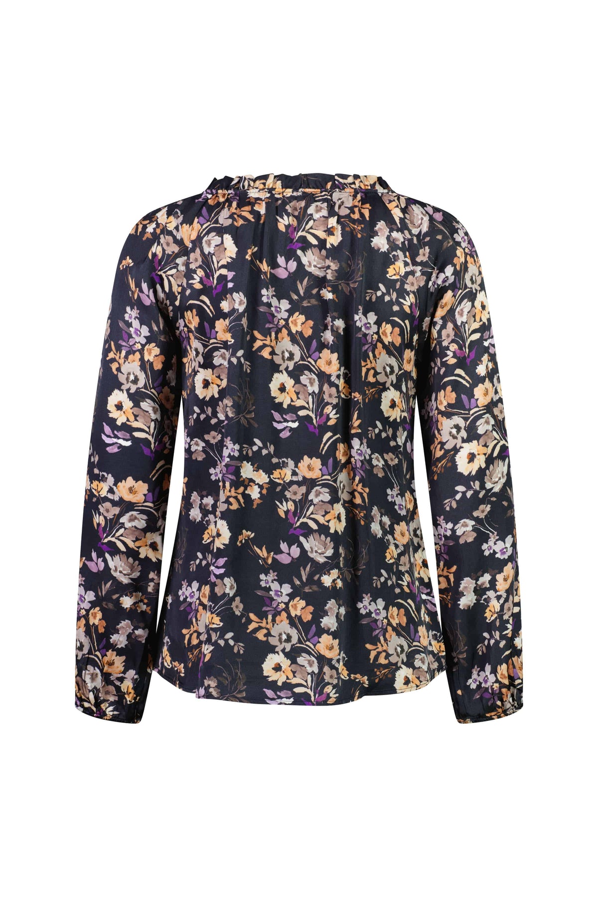The Vassalli V-Neck Top – Flora features a dark satin background with a multicolored floral print in yellow, white, and purple. This loose-fit blouse has an elegant v-neckline and subtle gathers for added style.