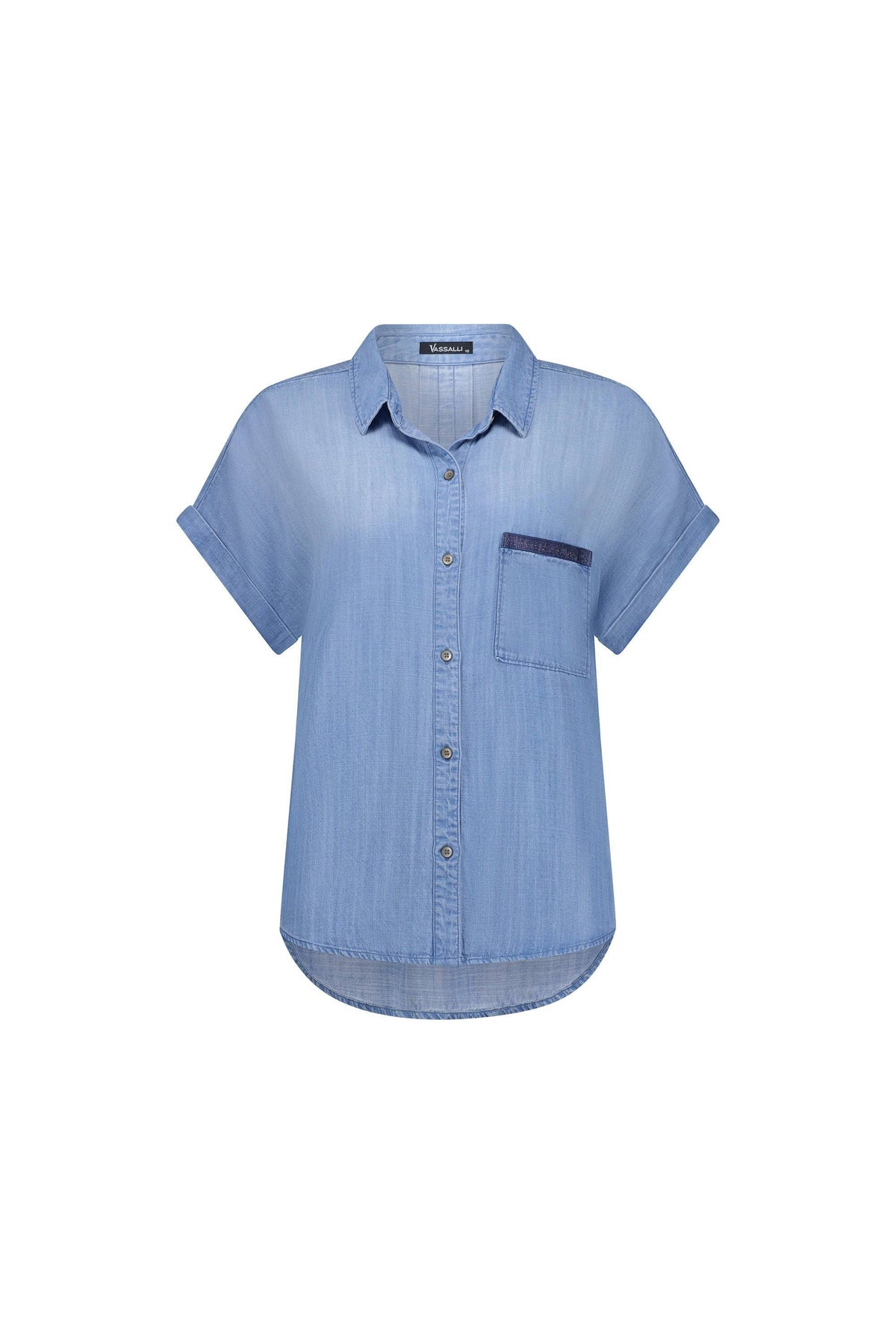 The Vassalli Shirt - Blue Wash is a light blue, short-sleeve button-up Tencel shirt with a collar and a single chest pocket accented by darker blue trim. Displayed on a white background, this shirt features a relaxed, dropped shoulder design for effortless style and showcases a subtle blue wash for a modern look.