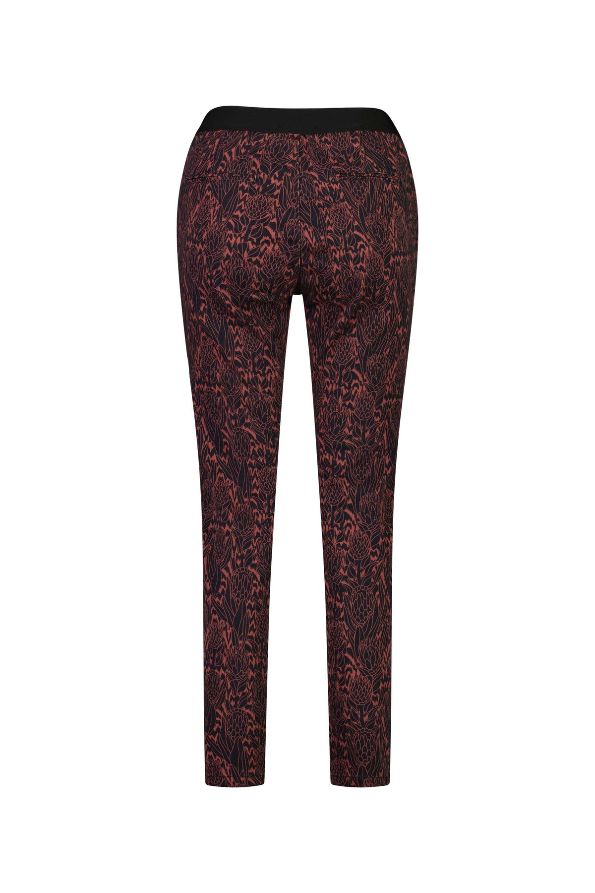 Back view of Vassalli Ankle Grazer Pant - Protea, a fitted, high-waisted skinny leg pant with a bold red and black abstract print, shown on a plain white background.