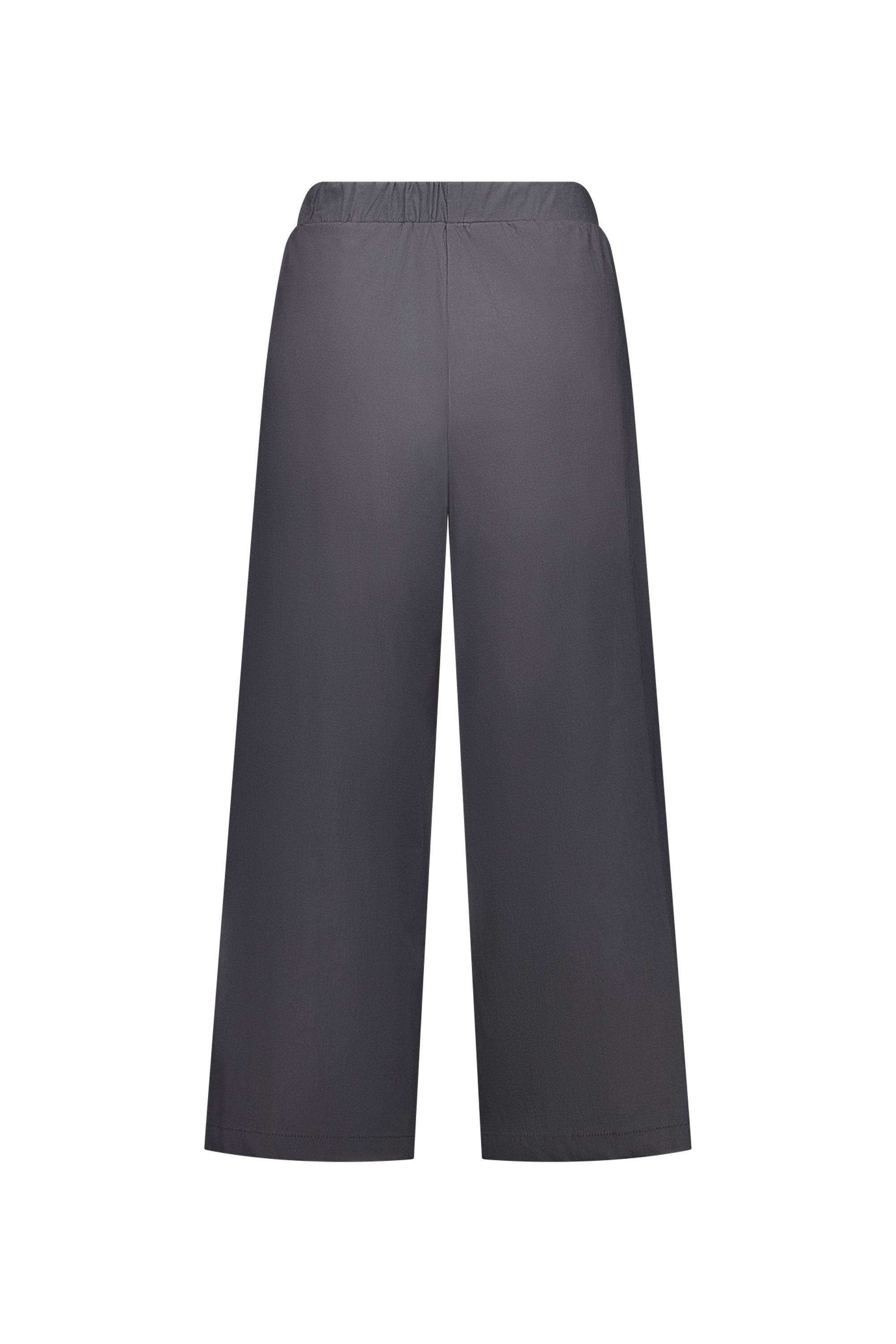 The Vassalli Paris Wide Leg Crop - Beluga features an elastic waistband and relaxed, wide-leg fit in dark gray stretch fabric. Ankle-length and shown from the back, these pants are expertly made in New Zealand.