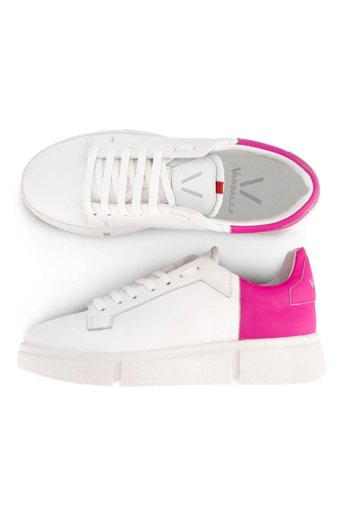 The Vassalli VS-001 White/Fuchsia Laced Sneaker features a minimalist leather design, thick platform soles, white laces, and bright fuchsia heel accents; shown from top and side views.
