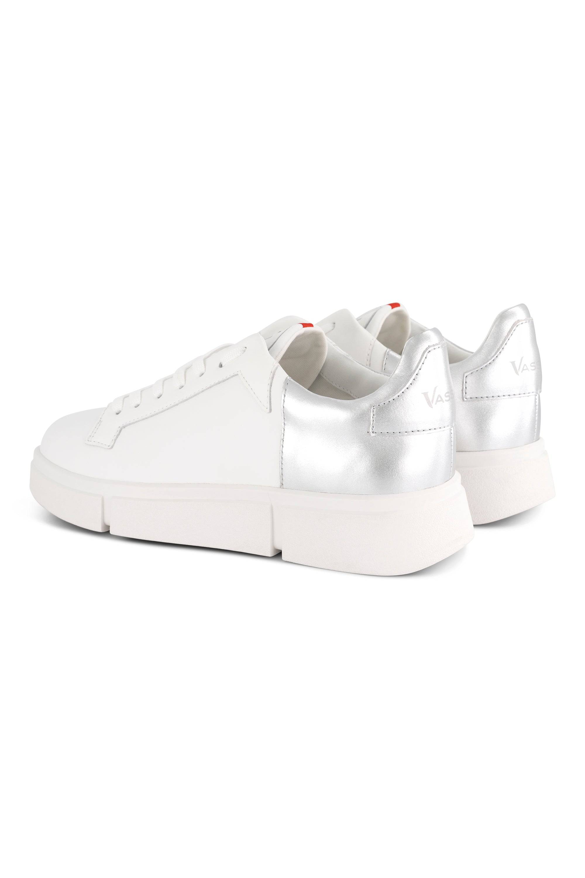 A pair of Vassalli VS-001 White/Silver laced sneakers with thick white soles and metallic silver heels, shown from the back and side on a white background.
