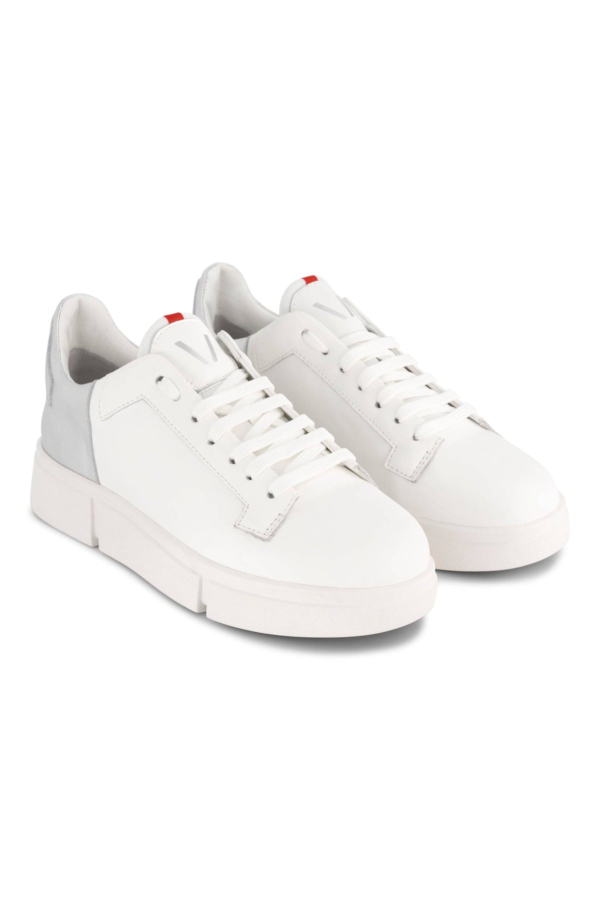 A pair of Vassalli VS-001 White/Silver laced sneakers with white uppers, silver accents, and subtle red tongue details is displayed on a plain white background.