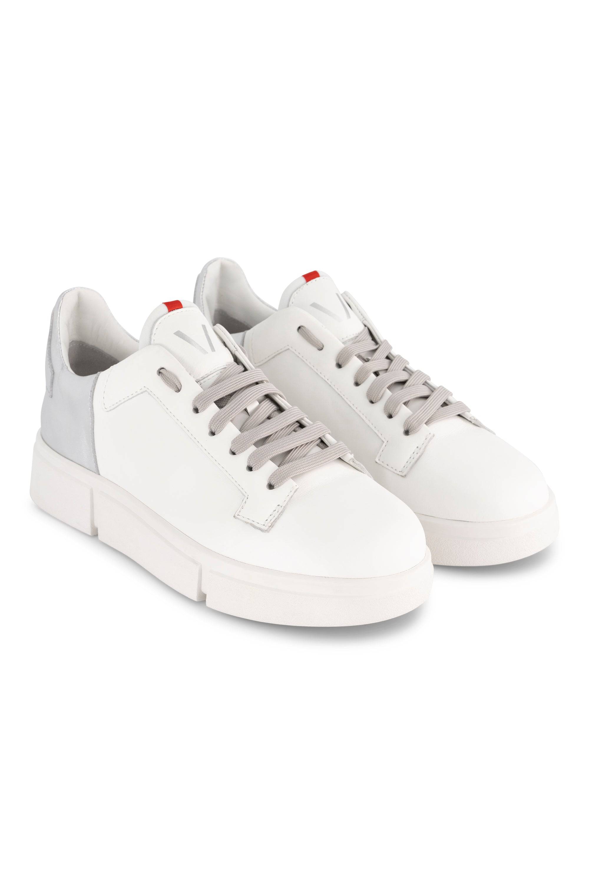 Vassalli VS-001 White/Silver laced sneakers with light gray accents, gray laces, and a small red detail on the tongue are displayed on a white background.