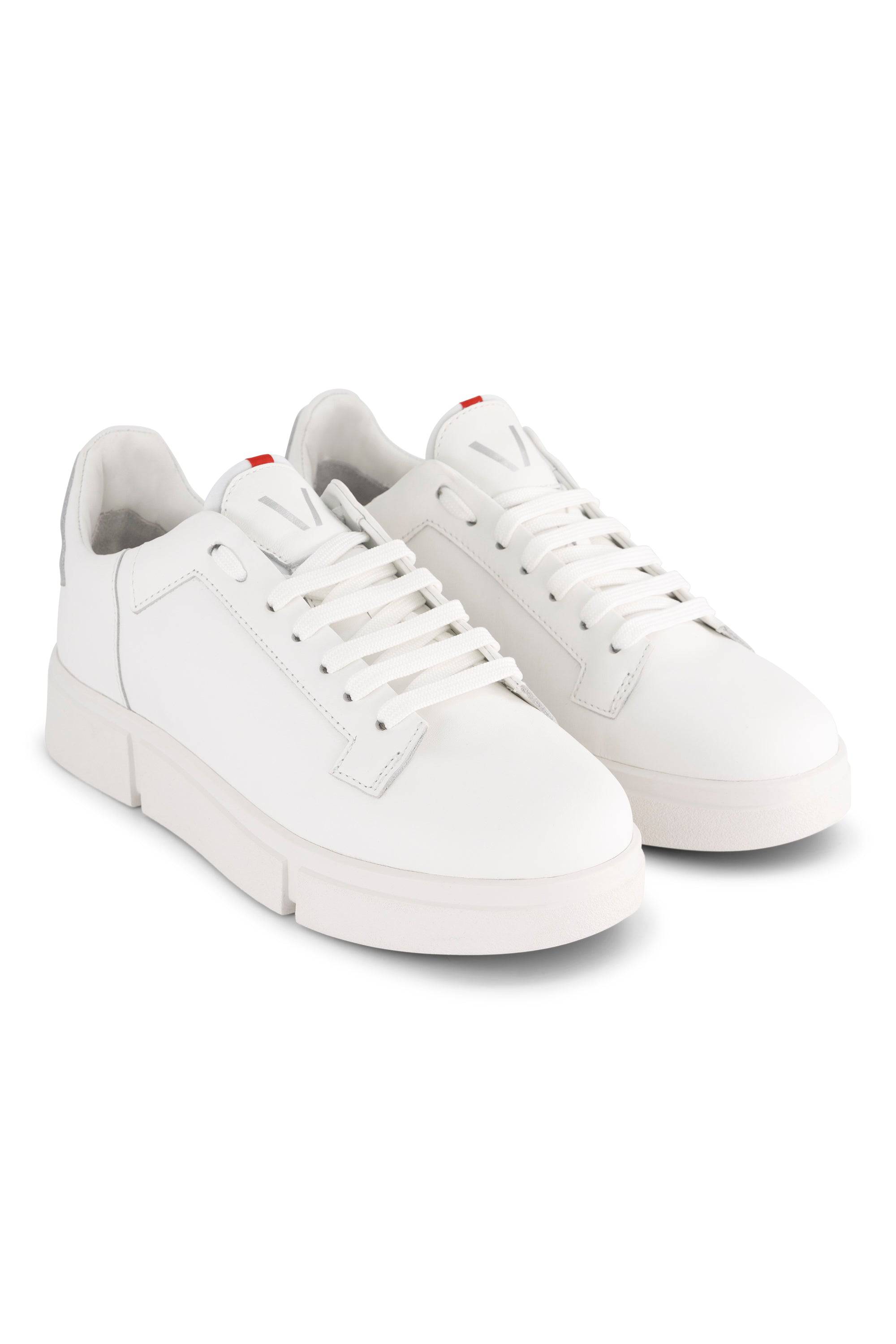 The Vassalli VS-001 White/White Laced Sneaker features white laces and soles, subtle branding on the tongue, and a small red accent near the top lace hole.