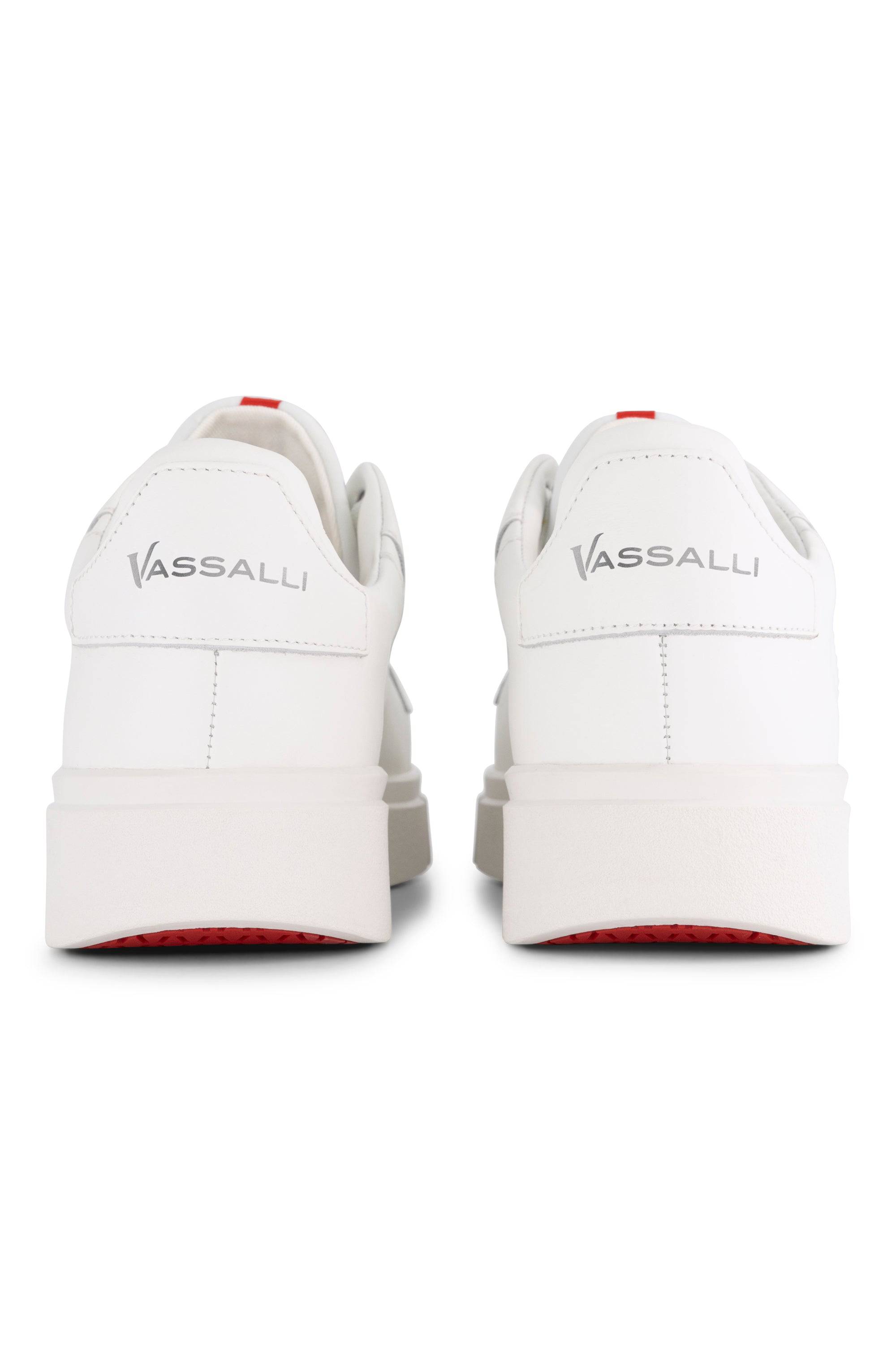Back view of the Vassalli VS-001 White/White laced sneaker: white leather platform design with thick soles, "VASSALLI" in gray on heel tabs, and red accents on the outsoles for a stylish finish.