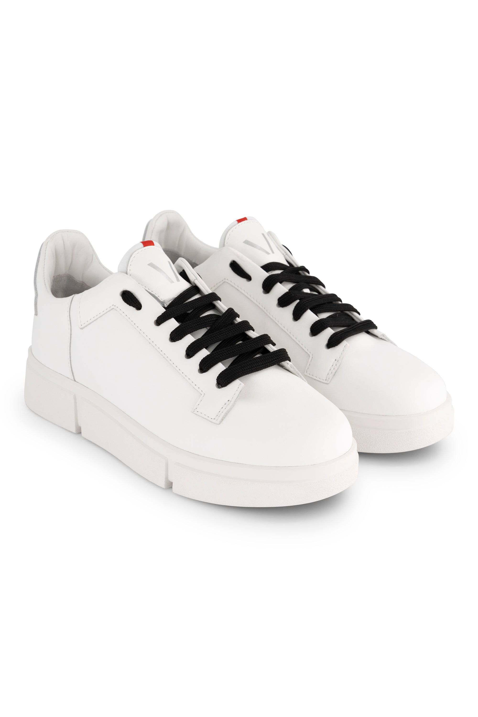 The Vassalli VS-001 White/White Laced Sneaker features white uppers, black laces, white soles, and subtle red accents on the tongue, shown against a plain white background.