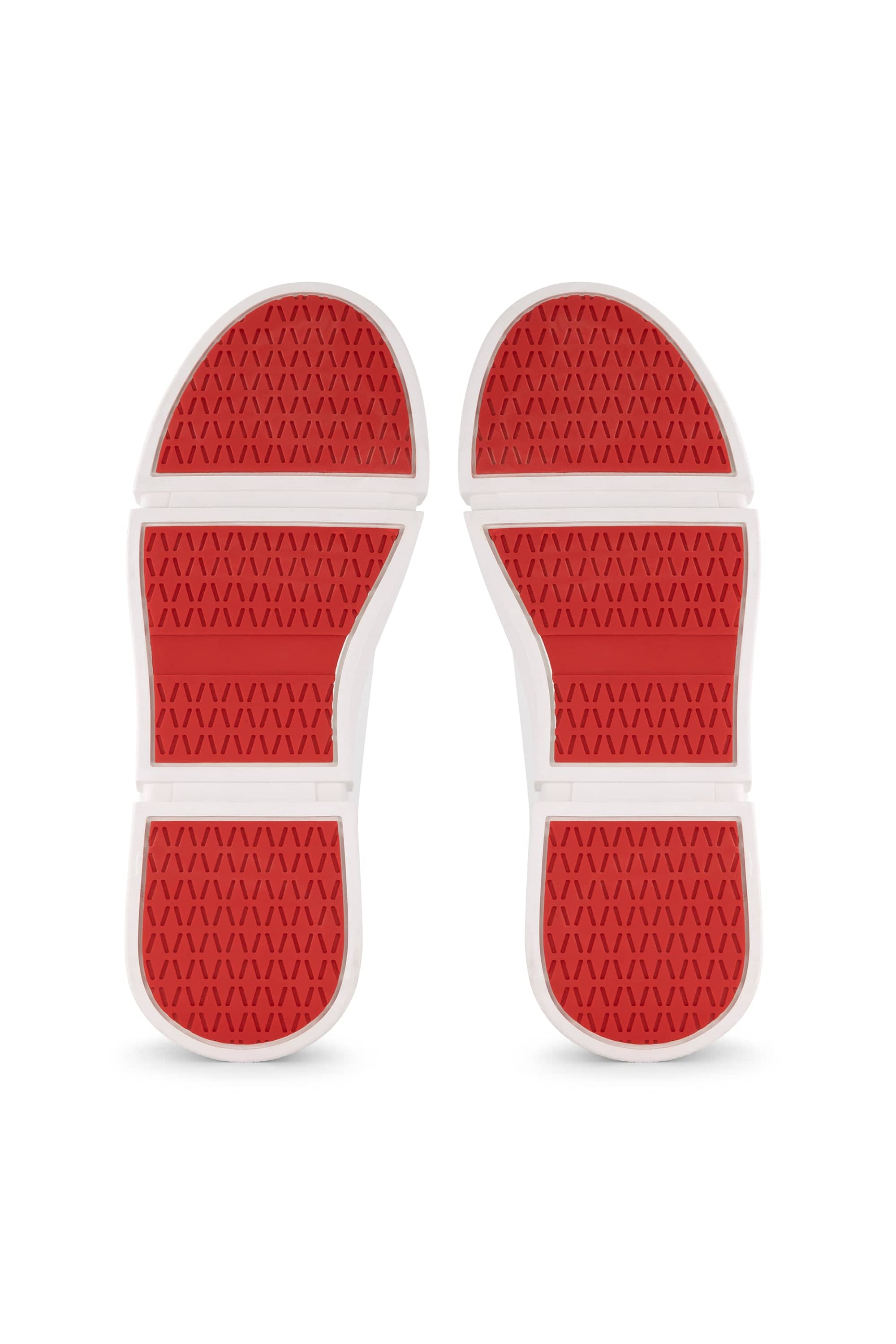 A pair of Vassalli VS-001 White/White laced sneakers is shown from the bottom, highlighting red soles with a hexagonal tread pattern and white grooves dividing each section.