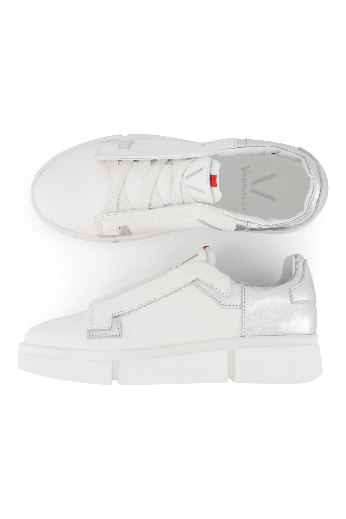 The Vassalli VS-004 White/Silver Laceless Sneaker features white leather, silver heel accents, and thick white soles. Displayed from top and side views on a white background, these shoes showcase a sleek, modern platform design.