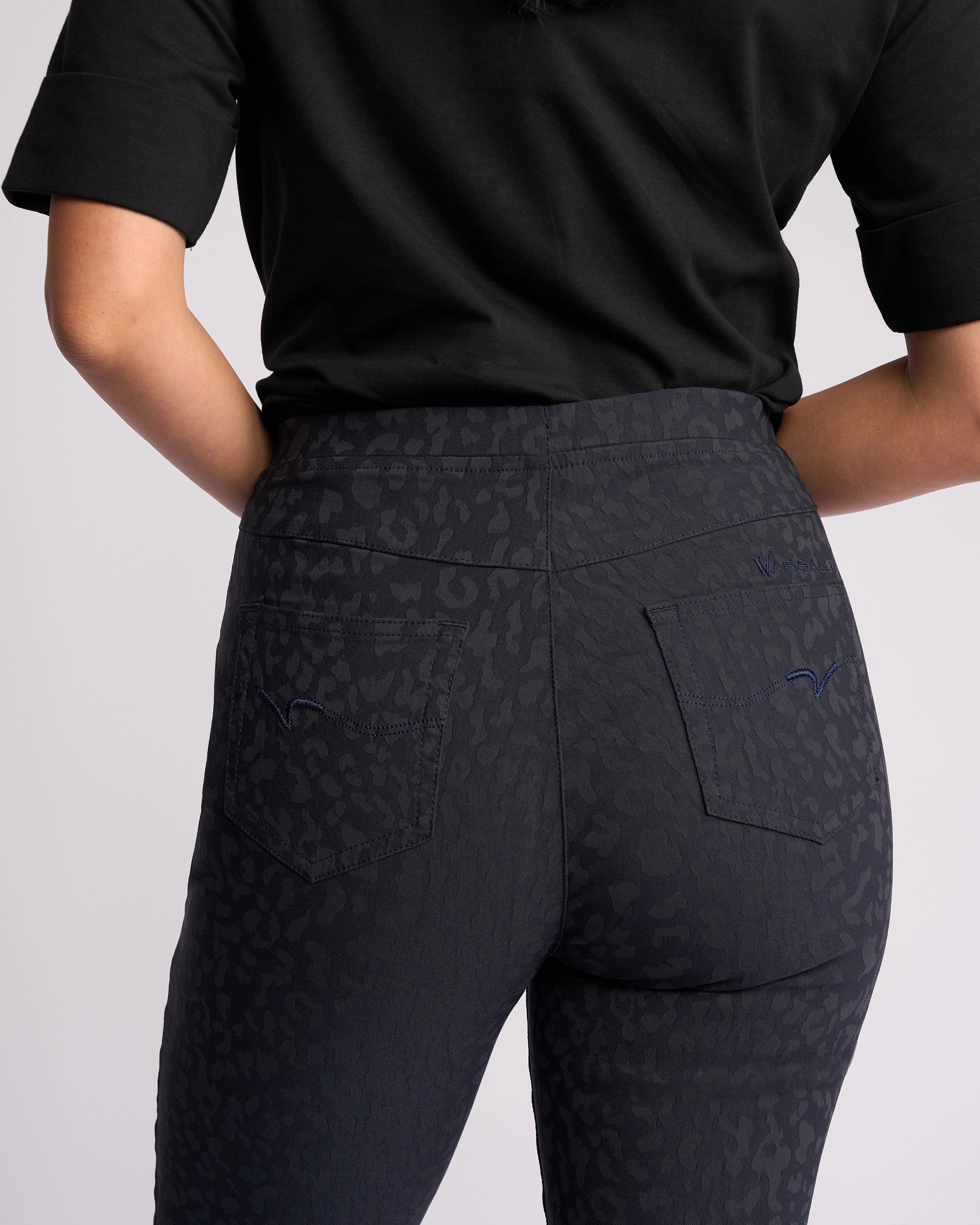 A person is shown from the back wearing Vassalli's Origin Pull On - Navy Embossed, highlighting the fit, pocket details, and sleek look of the stretch fabric.