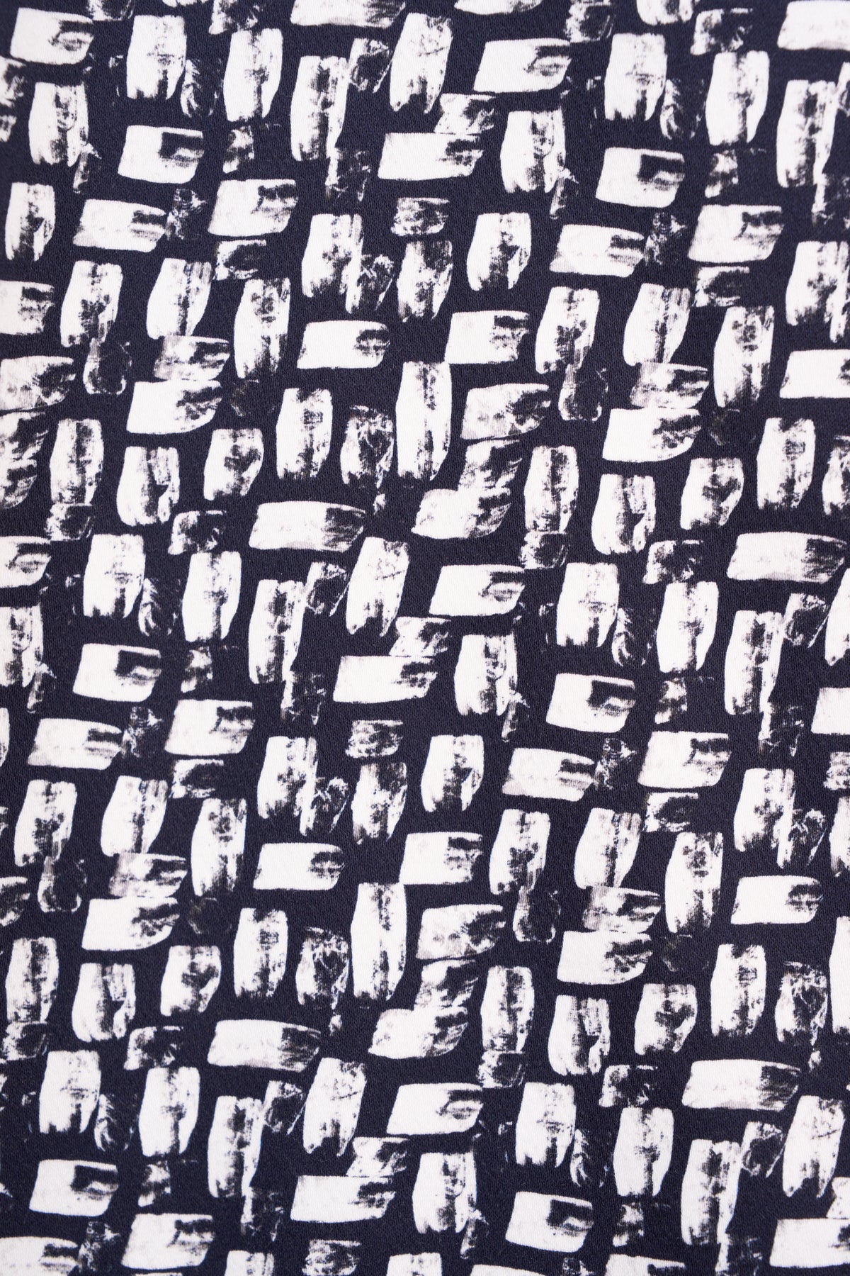 The Sierra 7/8 Pant - Cove by Vassalli features an abstract, grid-like pattern of white brush strokes on a dark base, adding artistic flair and texture that echoes the modern elegance found in slim fit styles.