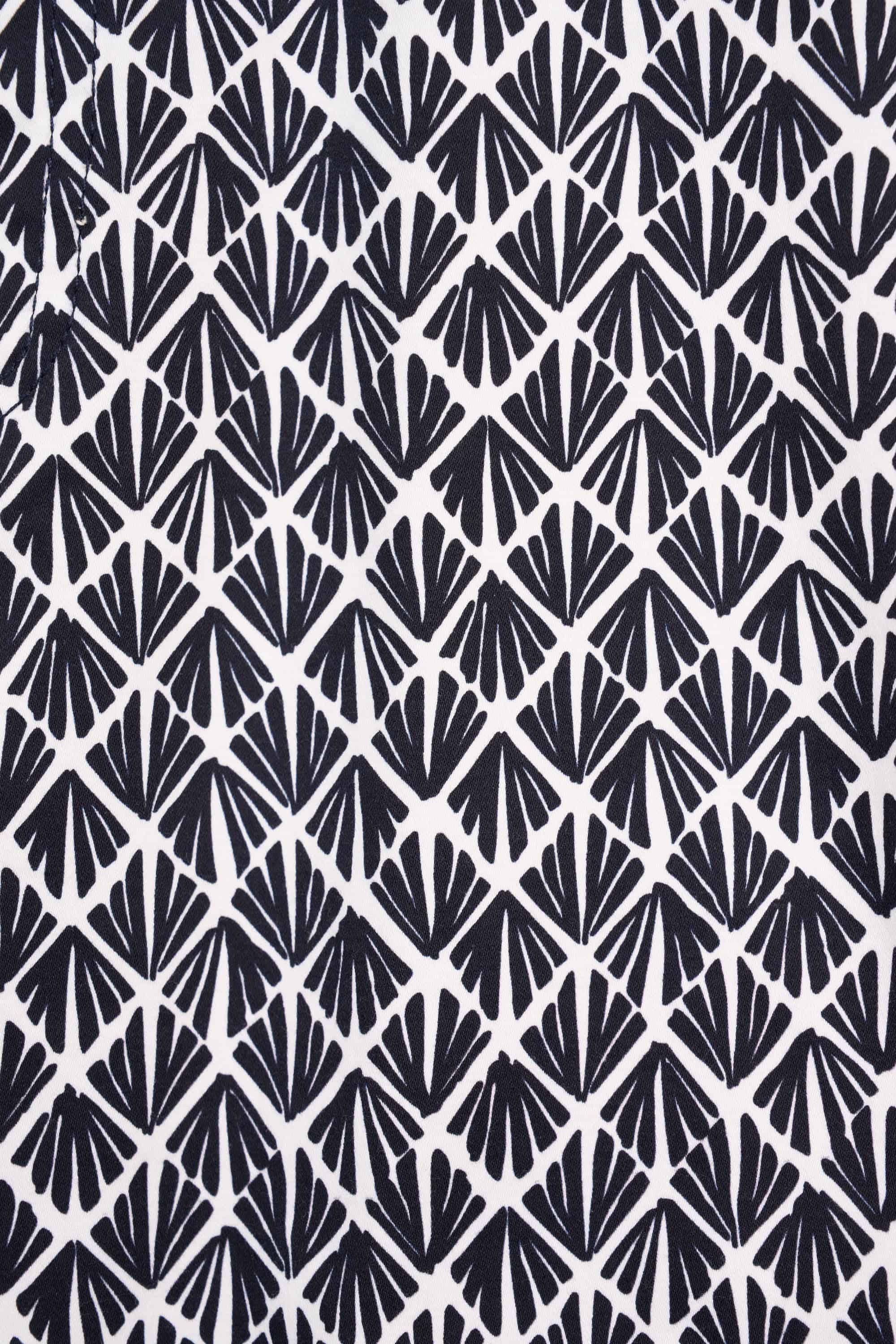 The Vassalli Poppy Lightweight Skirt - Fan features a bold black and white geometric fan pattern on stretch fabric, offering a stylish, symmetrical look ideal for everyday wear or as a statement printed skirt.