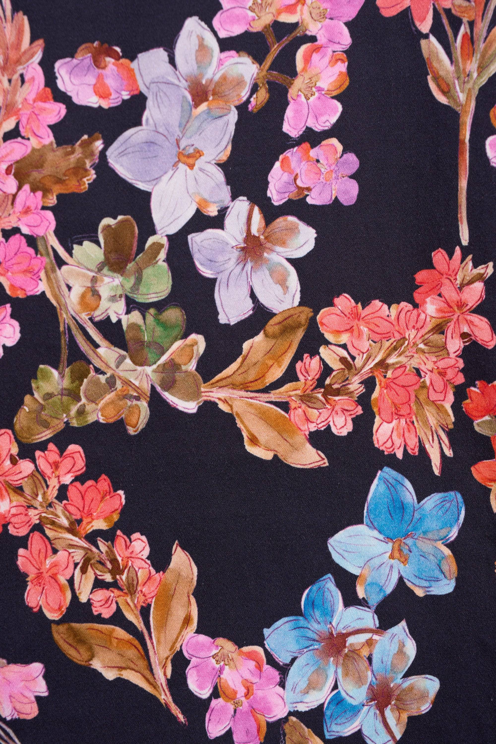 The Vassalli Poppy Skirt - Willa features a hand-painted watercolor-style floral pattern with pink, purple, and blue petals plus green leaves on a black background, making it perfect for everyday wear.