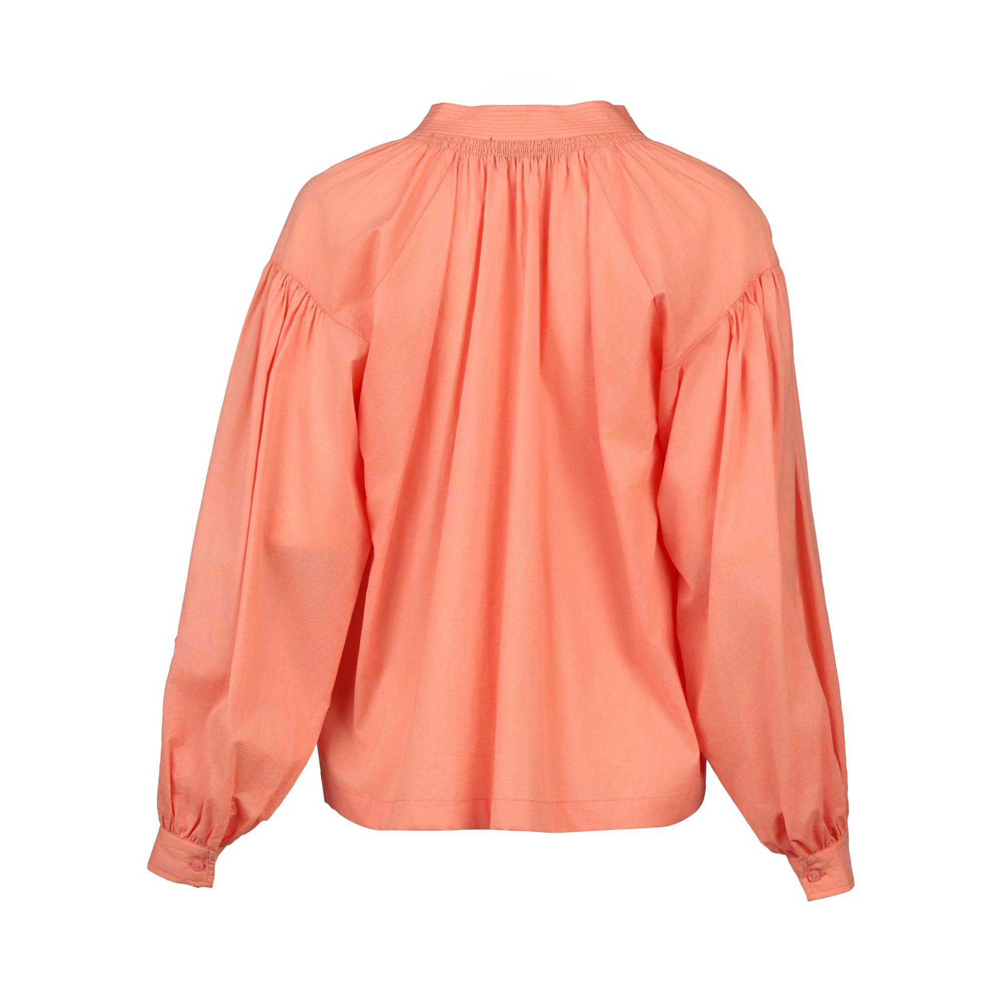 The Vassalli Placket Shirt in Apricot is shown from the back, highlighting its relaxed fit, stand collar, balloon sleeves, and gathered fabric at the shoulders and cuffs.