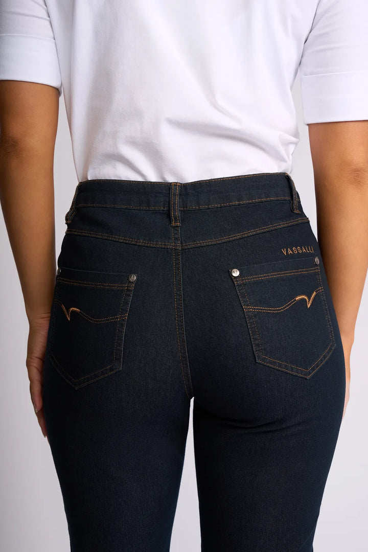 A person wearing a white shirt and dark blue Vassalli Alfa Short - Indigo Denim (Contrast Stitch) is shown from the back, highlighting the fit and design of the shorts’ back pockets.