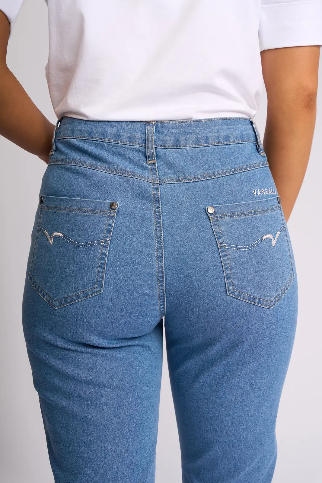 A person is shown from the back wearing the Vassalli Alfa Short - Light Denim (Contrast Stitch), highlighting the pockets and waistband of these lightweight stretch denim shorts, paired with a white t-shirt.