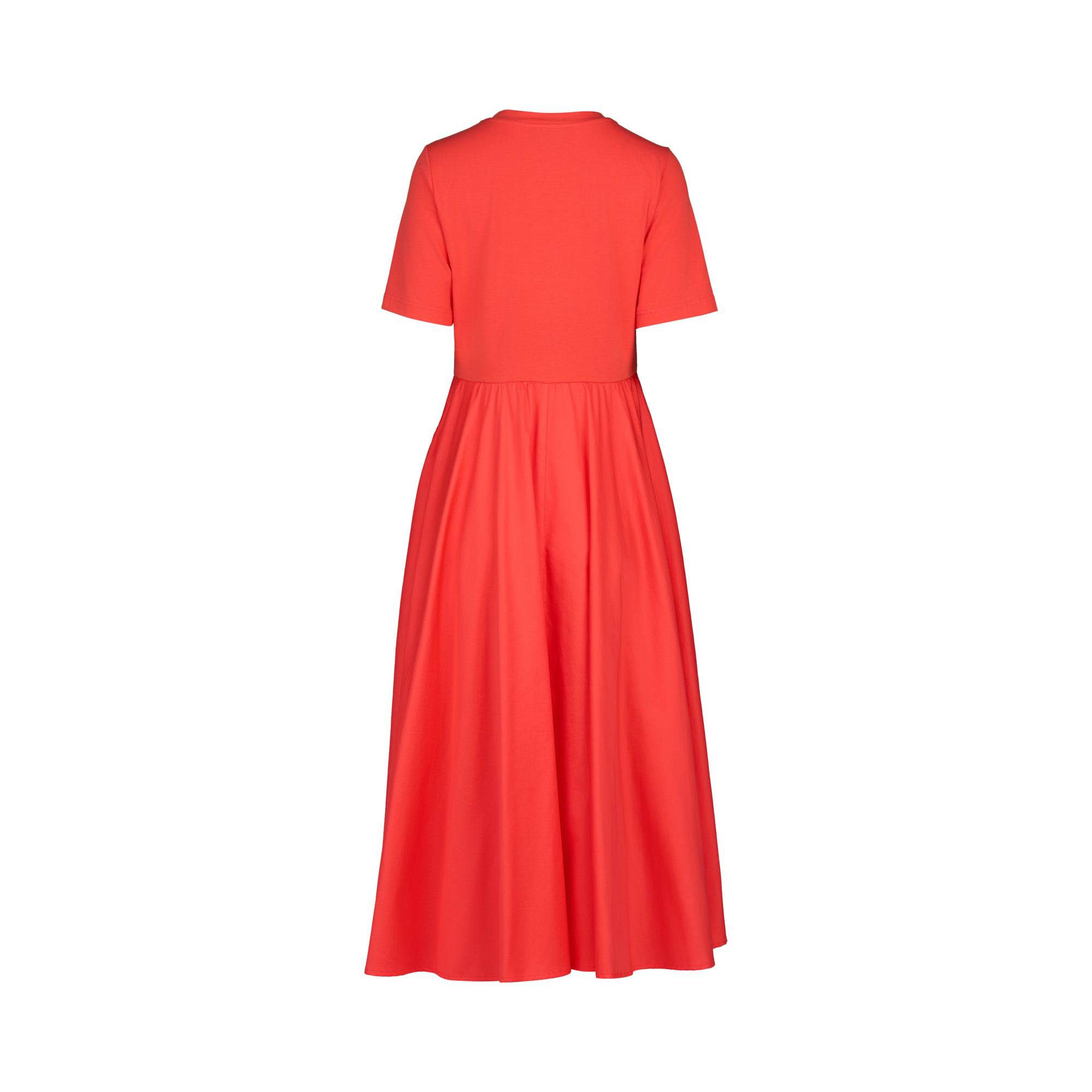 The T-Shirt Dress - Aperol by Vassalli is shown from the back in bright red, featuring short sleeves, an ankle-length flared skirt, fitted bodice, and crafted from soft cotton-elastane for comfort and movement.