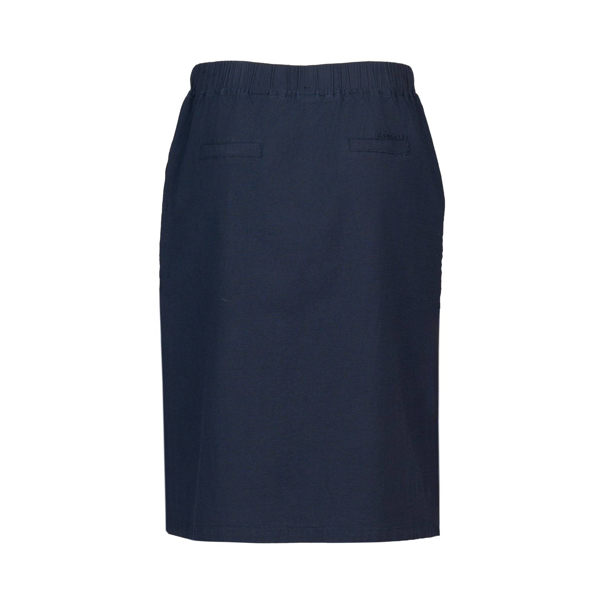The Vassalli Belen Skirt - Ink is a navy knee-length pull-on skirt with an elastic waistband, two back welt pockets, and a tailored design, shown against a white background.