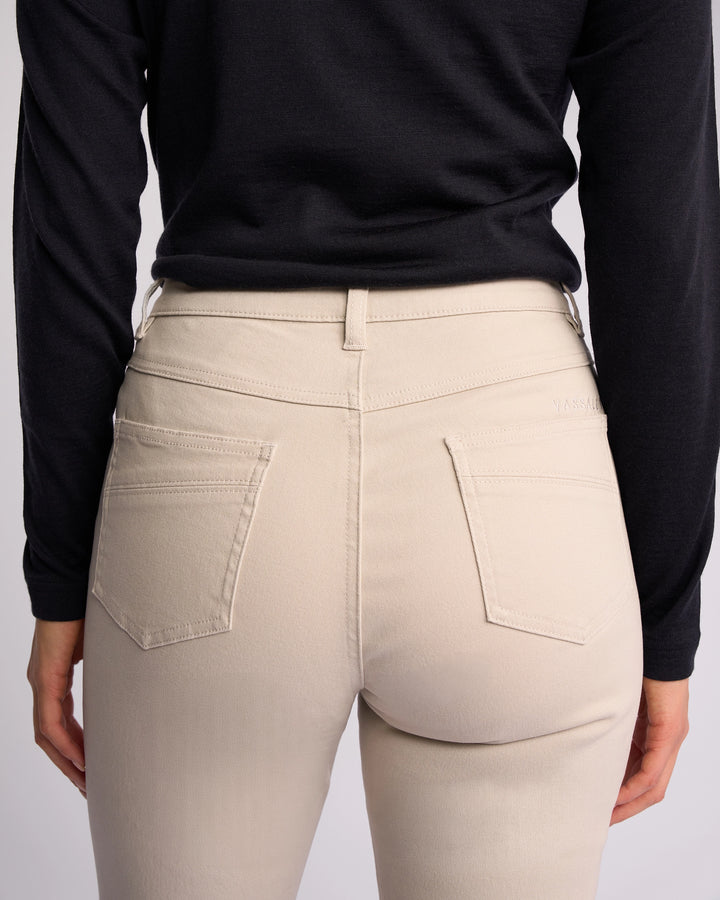 A person is seen from the back wearing Vassalli Studio Jean - Pumice, highlighting the waist, upper legs, and visible back pockets.